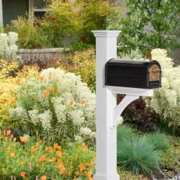 black mailbox on a white post