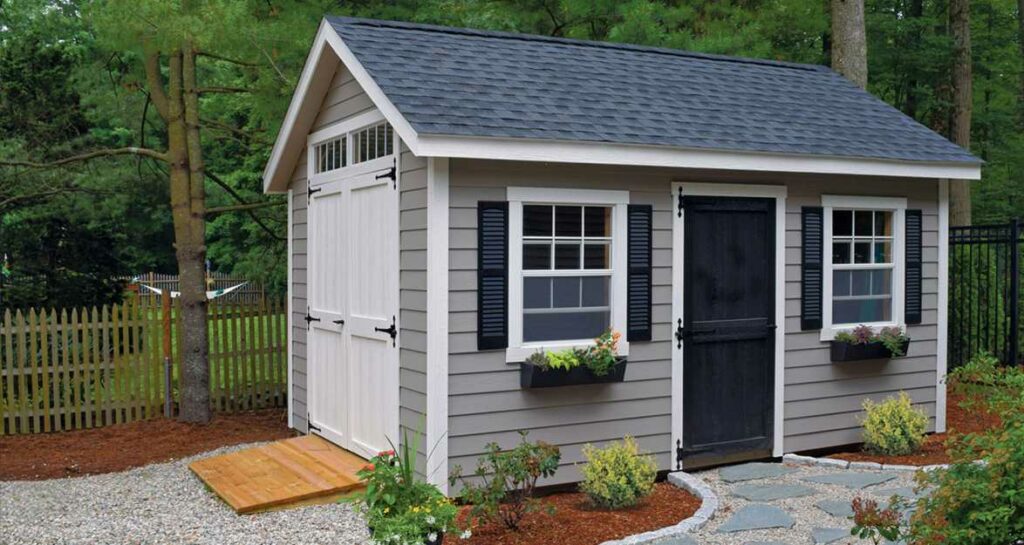 small garden shed with dark blue shingles and light siding