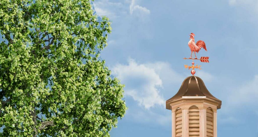 a rooster weathervane on a cupola