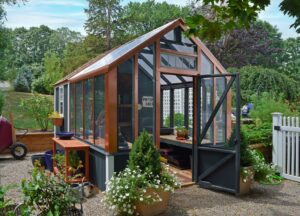 A dark green greenhouse with copper accents