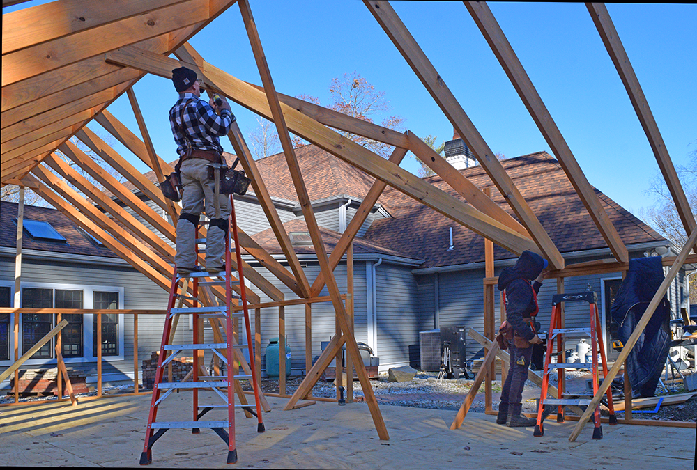 The Outdoor Personia team building a greenhouse on site
