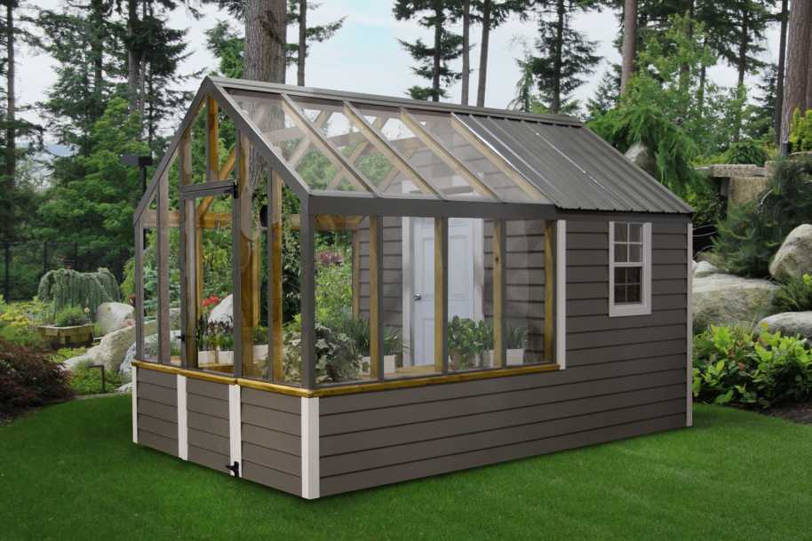 A grey greenhouse with white accents and a place to keep tools