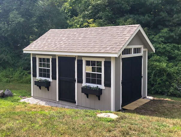 A Custom A-frame shed with flowerboxes in Norwell, Massachusetts