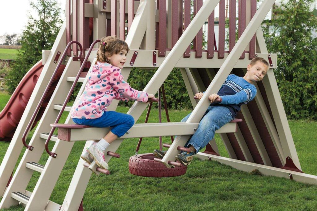 Two children swinging on a swing