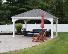 Vinyl poolside pavilion with hip shingle roof and vinyl columns is perfect addition to this backyard.