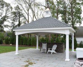 Large pavilion with rock front bar and stained T&G ceiling boards, plus vinyl columns, and features cupola accent.