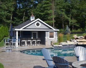This beautiful poolhouse includes a bathroom changing area, plus a storage room, and also there is full bar.