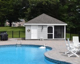 Poolhouse with storage area and a full screened in sitting area with plumbing and electric.