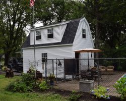Custom 1 car garage featuring full loft upstairs with gambrel roof and dormers.