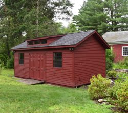 This 12x24 red painted storage shed has a dormer added with double door & ramp