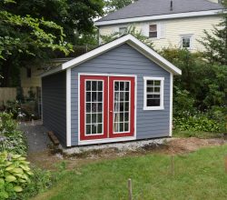 This 12x18 backyard shed features double full glass doors and vinyl siding exterior and is on a crushed rock foundation.