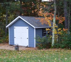 12x16 Storage Shed features vinyl siding & trim and shingled roof with double doors for equipment with a ramp
