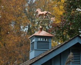 Custom cupola painted with louvers and transom windows plus a weathervane.