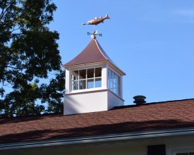 Vinyl cupola with shiny copper roof and fixed glass windows with a bass weathervane.