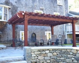 Red stained wood pergola on patio deck