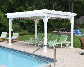 10x12 Traditional White vinyl pergola next to pool featuring an EZ shade and with the all vinyl construction it will last.