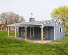 This 3 stall horse barn features painted wood siding, gable roof, and a open porch area.