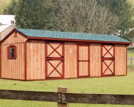 This horse barn features tack room and 2 stalls, and windows with shutters.