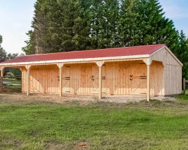 Horse Barn with red metal roof, 3 stalls plus a tack room, with porch overhang.
