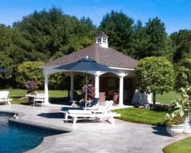 Pavilion with wall on the back for privacy and features cupola accent and vinyl columns.
