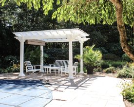 Poolside pergola features white vinyl and an ez shade, great location.