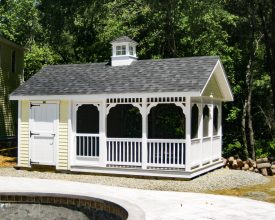 This pool house features screened in area with storage, vinyl siding exterior and a cupola accent.
