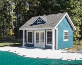 Pool House featuring vinyl siding exterior, white trim, oversized windows, A-frame dormer with window, and shingled gable roof.