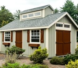 12x18 Personalized storage shed accented with barn style doors, transom windows and a custom cupola.