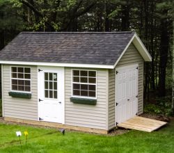This 10x14 outdoor storage shed features window boxes, large windows, and double raised panel doors with ramp.