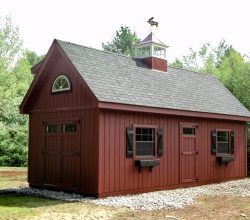 This 12x24 custom storage shed is personalized with transom window doors, window shutters and boxes, and a cupola with a weathervane.