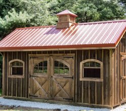 This 12x18 wooden storage shed has custom cedar stained siding, with metal roof and a cupola.