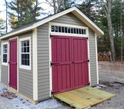 This 10x14 shed features vinyl siding and double shed doors with transom window and shingle roof.