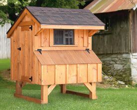 Chicken Coop is constructed with cedar board and batten siding, small sliding window offers ventilation.
