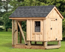 This chicken coop is smaller but still offers enough room with its run area, built with wood siding and a shingled roof.
