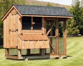 This chicken coop features nesting boxes, a screened in run area and ventilation windows.
