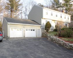 This big 2 car garage features vinyl siding, shingled roof & matches the house.