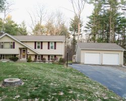 This custom detached garage includes, vinyl siding, gable roof, & concrete foundation.