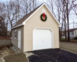 Custom 16 x 24 detached garage with vinyl siding walls & shingled roof.