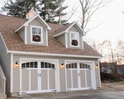 This personalized garage features 2 story, exterior full size stairs, dormers, carriage house garage doors, & electrical.