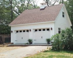 This beautiful 2 car garage features lots of windows, second story, cupola, & vinyl siding with shingle roof.