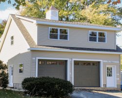 This amazing garage has lots of storage space, second story, full width dormers, & vinyl siding with shingle roof.