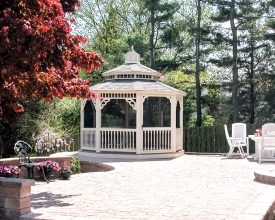 This patio gazebo features vinyl construction, screened, and a shingle roof.