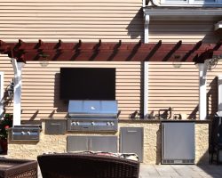 outdoor cooking under narrow pergola