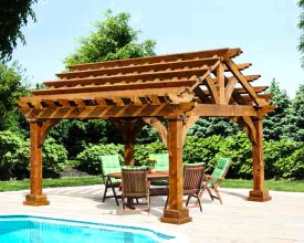 This Stained cedar pergola is unique with its gable design and looks good beside the pool offering place to relax.