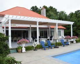 Vinyl pergola with round columns and a shade canopy over a beautiful patio by the pool!