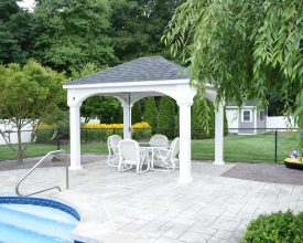 Custom vinyl pavilion featuring a hip roof, square posts, and electrical by the pool!