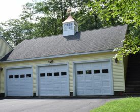 Custom cupola on a 3 car garage featuring windows, copper roof, and a rooster weathervane.