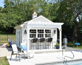 Detailed pool house with an A frame roof, large windows, french doors, electrical, a cupola, an arrow weathervane, and an attached vinyl pergola!
