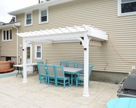 Attached to house vinyl pergola featuring square posts, electrical, and a shade canopy!